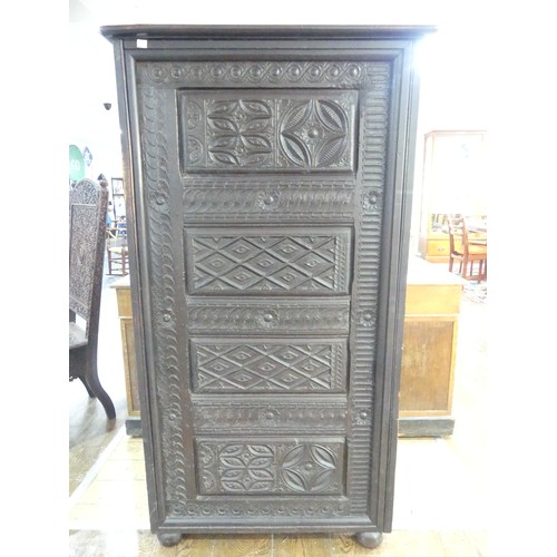 651 - An antique carved oak Cupboard, with heavily carved decoration, W 82cm x D 46cm x H 151cm.... 