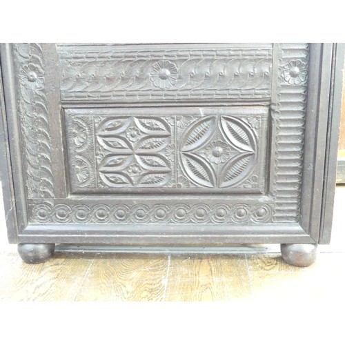 651 - An antique carved oak Cupboard, with heavily carved decoration, W 82cm x D 46cm x H 151cm.... 