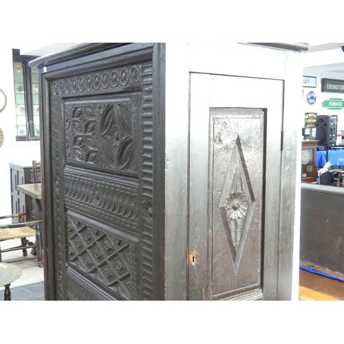 651 - An antique carved oak Cupboard, with heavily carved decoration, W 82cm x D 46cm x H 151cm.... 