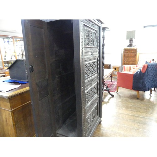 651 - An antique carved oak Cupboard, with heavily carved decoration, W 82cm x D 46cm x H 151cm.... 