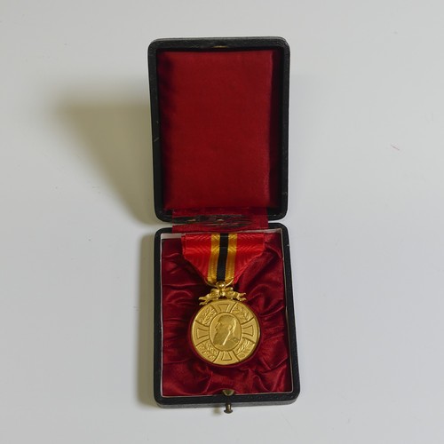 370 - A collection of eight Belgian orders and medals, including a “Croix D’or d’officier” of the Order of... 