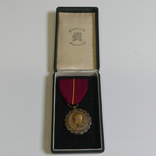 370 - A collection of eight Belgian orders and medals, including a “Croix D’or d’officier” of the Order of... 