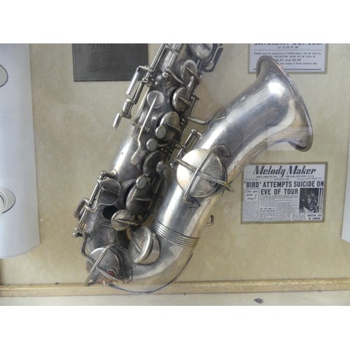 368 - Charlie Parker interest; a display case containing a silver plate saxophone made by Buescher, serial... 