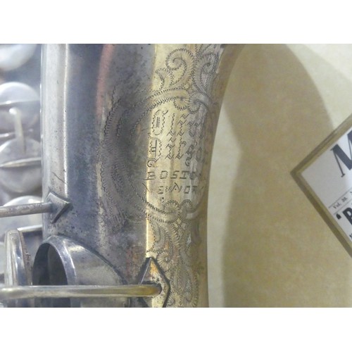 368 - Charlie Parker interest; a display case containing a silver plate saxophone made by Buescher, serial... 