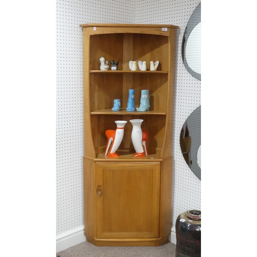 636 - An Ercol blonde 'Windsor' Corner Unit, with open shelving above a cupboard, W 76cm x D 42cm x H 180 ... 