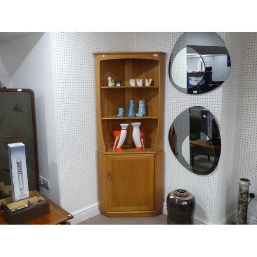 636 - An Ercol blonde 'Windsor' Corner Unit, with open shelving above a cupboard, W 76cm x D 42cm x H 180 ... 