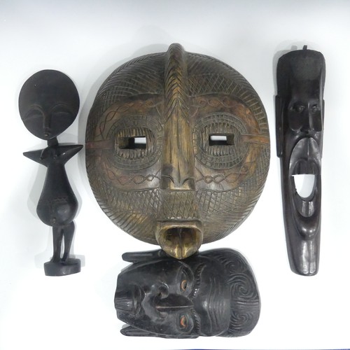 473 - Four pieces of Tribal Art, including three masks and a wooden fertility statue (4)