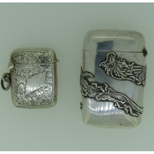 32 - A Japanese silver Vesta Case, with jungin mark, embossed with two scrolling dragons, 6cm high, toget... 