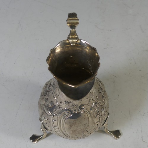 69 - An early George III silver Cream Jug, hallmarked London 1766, makers mark unclear, of baluster form ... 