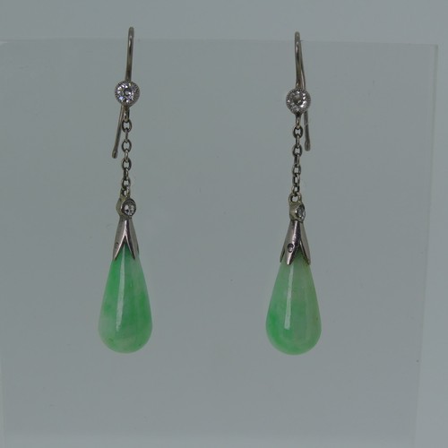 A pair of early 20thC Jade Earrings, the pear shaped drops in unmarked white metal with millegrain set diamond above on a fine chain with a diamond set hook fitting, the jades approx 17mm long, 3.7cm total length from the top diamond.