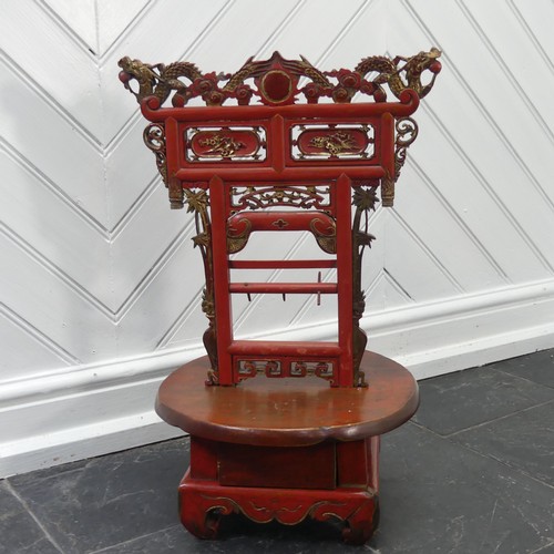 156 - A Chinese red and gold lacquer foot binding stool, decorated and carved with two dragons at the top,... 