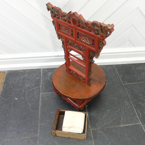 156 - A Chinese red and gold lacquer foot binding stool, decorated and carved with two dragons at the top,... 