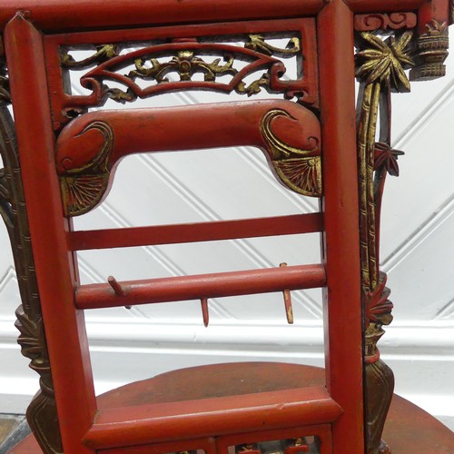 156 - A Chinese red and gold lacquer foot binding stool, decorated and carved with two dragons at the top,... 