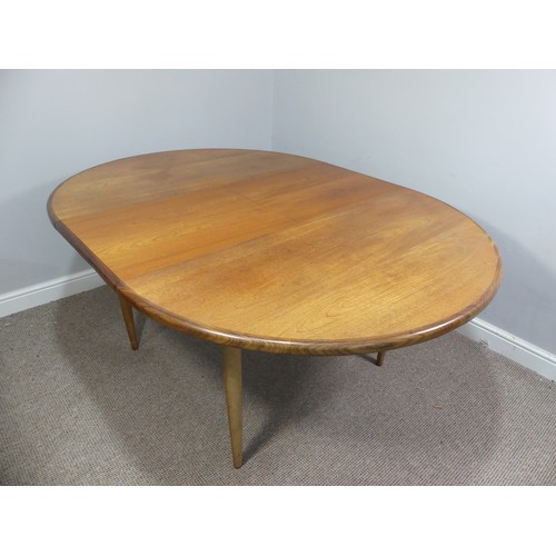 313 - A mid 20thC teak extending Dining Table, of circular form, raised on tapering legs, some scuffs and ... 