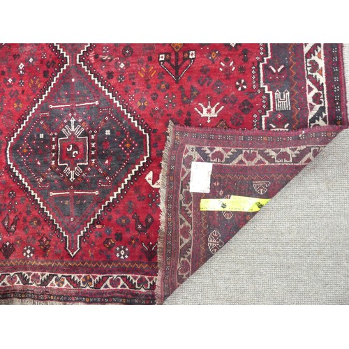 481 - Tribal rugs; a Kashquai Rug, hand-knotted with stylised tree of life and floral designs on a red gro... 