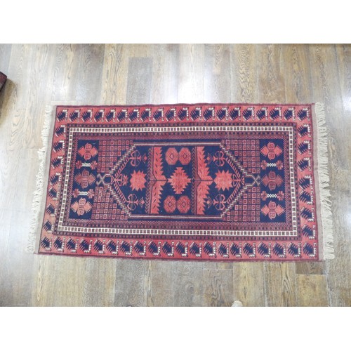 482 - Tribal rugs; an Afghan Rug, hand-knotted with geometric designs on a red ground, 100% wool, in fair ... 