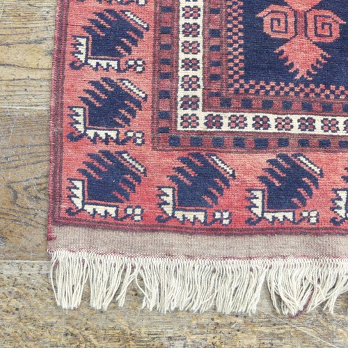 482 - Tribal rugs; an Afghan Rug, hand-knotted with geometric designs on a red ground, 100% wool, in fair ... 