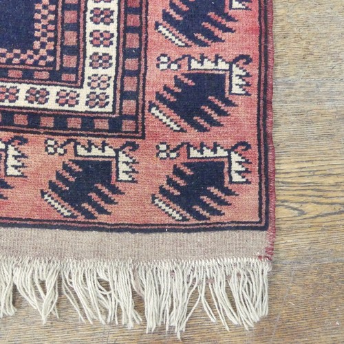 482 - Tribal rugs; an Afghan Rug, hand-knotted with geometric designs on a red ground, 100% wool, in fair ... 