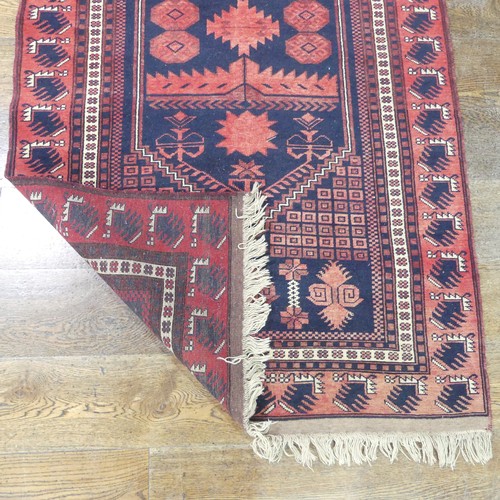 482 - Tribal rugs; an Afghan Rug, hand-knotted with geometric designs on a red ground, 100% wool, in fair ... 