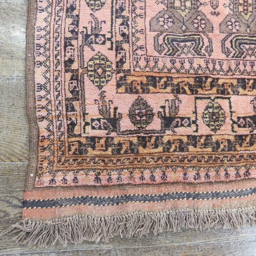 483 - Tribal rugs; an Afghan Rug, hand-knotted with tekke and geometric designs on a light red ground, 100... 