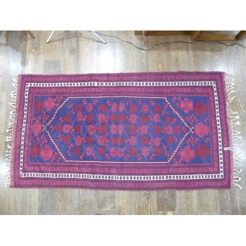 484 - Tribal rugs; an Afghan Rug, hand-knotted with geometric designs on a red ground, 100% wool, in fair ... 