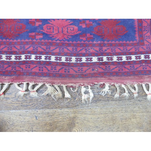 484 - Tribal rugs; an Afghan Rug, hand-knotted with geometric designs on a red ground, 100% wool, in fair ... 