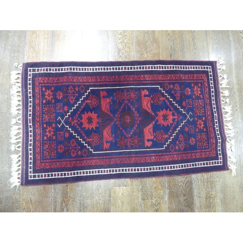 484 - Tribal rugs; an Afghan Rug, hand-knotted with geometric designs on a red ground, 100% wool, in fair ... 