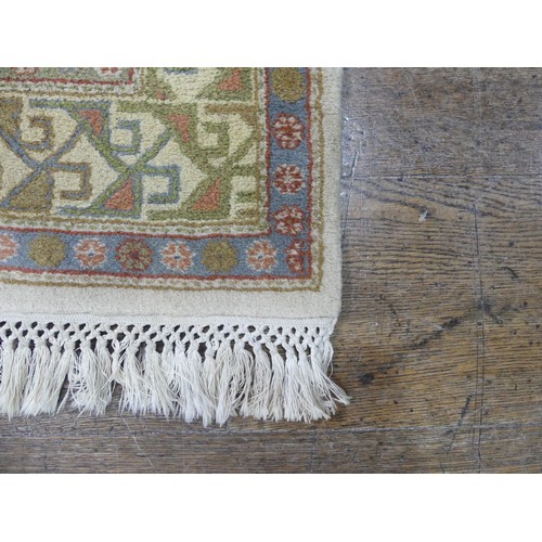 485 - Tribal rugs; a hand-knotted runner, cream ground woven with geometric designs, thick wool pile on co... 