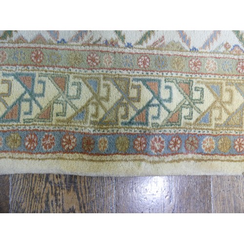 485 - Tribal rugs; a hand-knotted runner, cream ground woven with geometric designs, thick wool pile on co... 