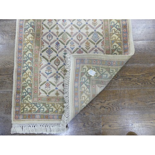 485 - Tribal rugs; a hand-knotted runner, cream ground woven with geometric designs, thick wool pile on co... 