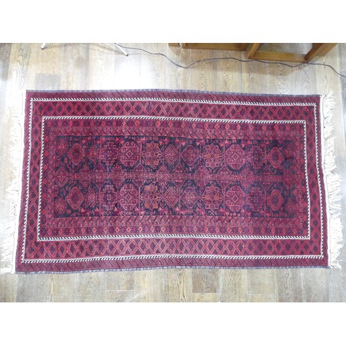 486 - Tribal rugs; an Afghan Rug, hand-knotted with geometric designs on a red ground, 100% wool, fringe w... 