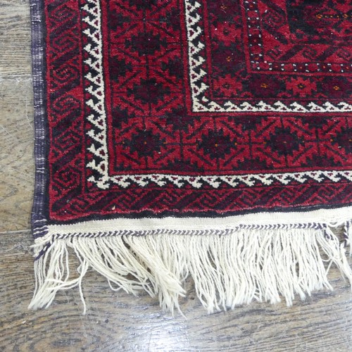 486 - Tribal rugs; an Afghan Rug, hand-knotted with geometric designs on a red ground, 100% wool, fringe w... 