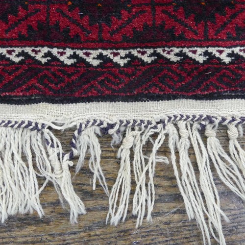 486 - Tribal rugs; an Afghan Rug, hand-knotted with geometric designs on a red ground, 100% wool, fringe w... 