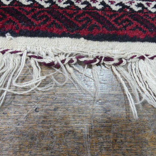 486 - Tribal rugs; an Afghan Rug, hand-knotted with geometric designs on a red ground, 100% wool, fringe w... 