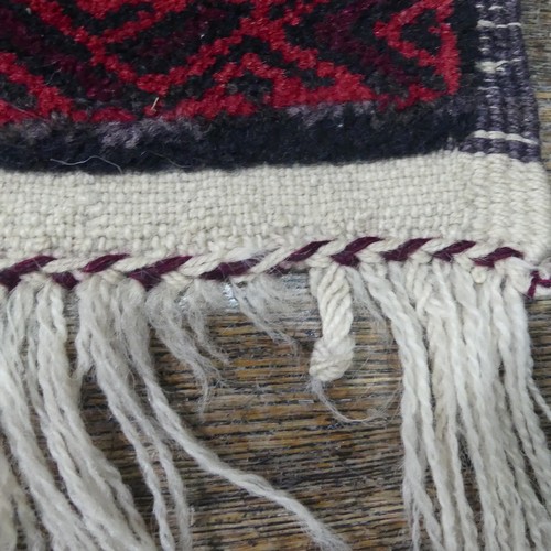 486 - Tribal rugs; an Afghan Rug, hand-knotted with geometric designs on a red ground, 100% wool, fringe w... 