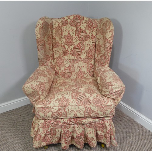 323 - An early 20thC oak framed wing Armchair, with patterned upholstery, the wings above outswept arms, o... 