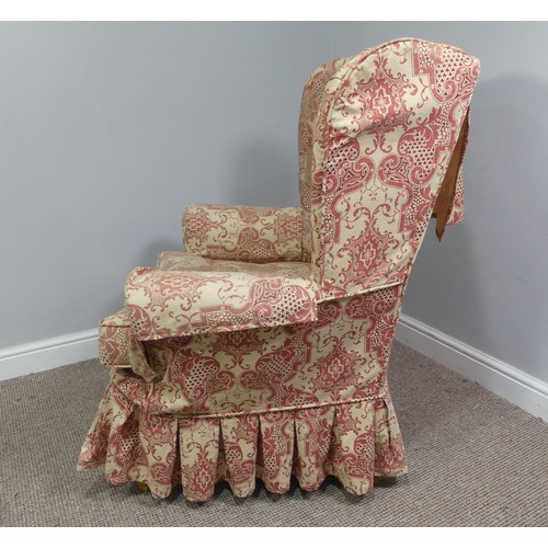 323 - An early 20thC oak framed wing Armchair, with patterned upholstery, the wings above outswept arms, o... 