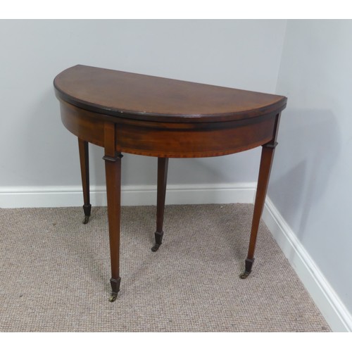 331 - An Edwardian mahogany inlaid demi-lune Card Table, with fold-over top lined with baize, raised on sq... 