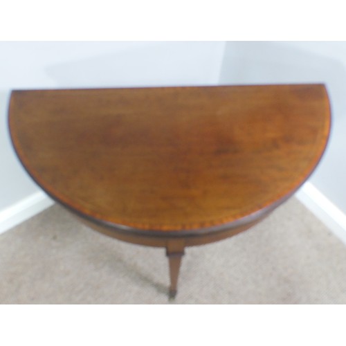 331 - An Edwardian mahogany inlaid demi-lune Card Table, with fold-over top lined with baize, raised on sq... 