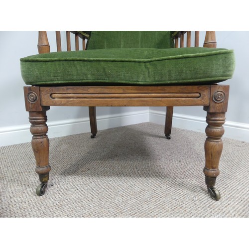 332 - A Victorian pitch pine framed Armchair, with stick back and scroll arms, upholstered green armrests,... 