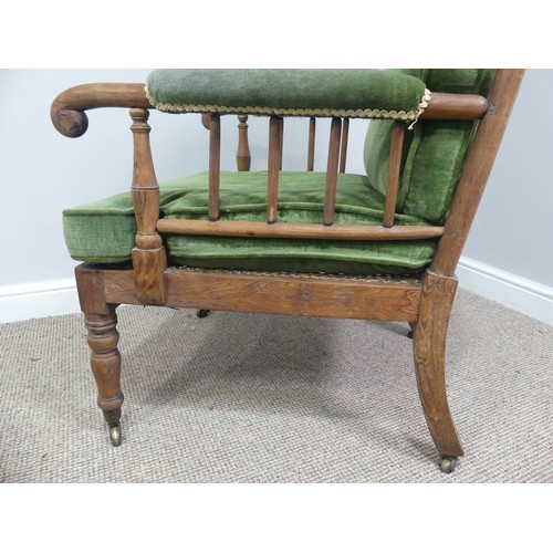 332 - A Victorian pitch pine framed Armchair, with stick back and scroll arms, upholstered green armrests,... 