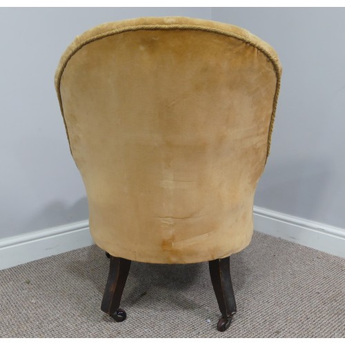 333 - A Victorian upholstered Nursing Chair, with yellow velvet upholstery, on turned front legs with cast... 