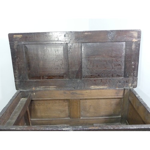 337 - A 17th century oak three panel Coffer, the front with carved panels below a carved frieze, on square... 