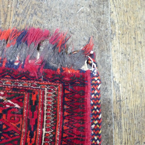 488 - Tribal Rugs; a Baluchi Tent Hanging, finely knotted with short pile, edges and fringing worn, 135cm ... 