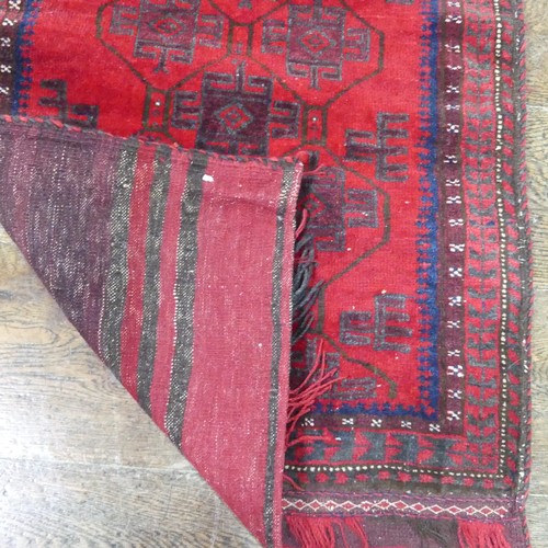 488 - Tribal Rugs; a Baluchi Tent Hanging, finely knotted with short pile, edges and fringing worn, 135cm ... 