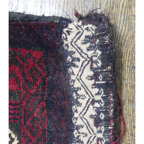 488 - Tribal Rugs; a Baluchi Tent Hanging, finely knotted with short pile, edges and fringing worn, 135cm ... 