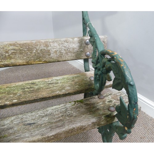 494 - Garden Furniture; a vintage green-painted cast iron Garden Seat, the bench ends in the Coalbrookdale... 