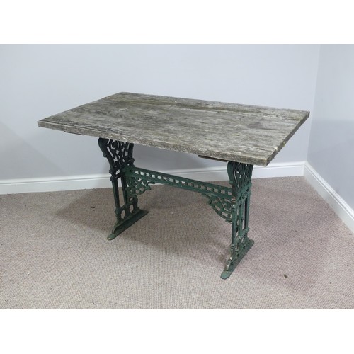 495 - Garden Furniture; a vintage green-painted cast iron Garden Table, the rectangular plank top, above a... 