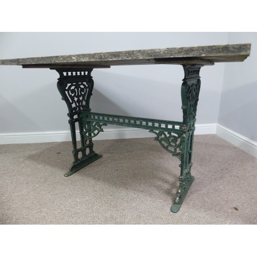 495 - Garden Furniture; a vintage green-painted cast iron Garden Table, the rectangular plank top, above a... 