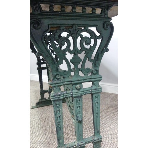 495 - Garden Furniture; a vintage green-painted cast iron Garden Table, the rectangular plank top, above a... 